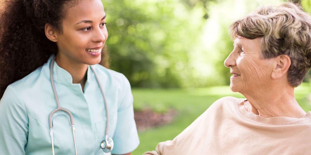 Young travel nurse helping an elderly patient