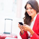 Young professional checking her phone at the airport