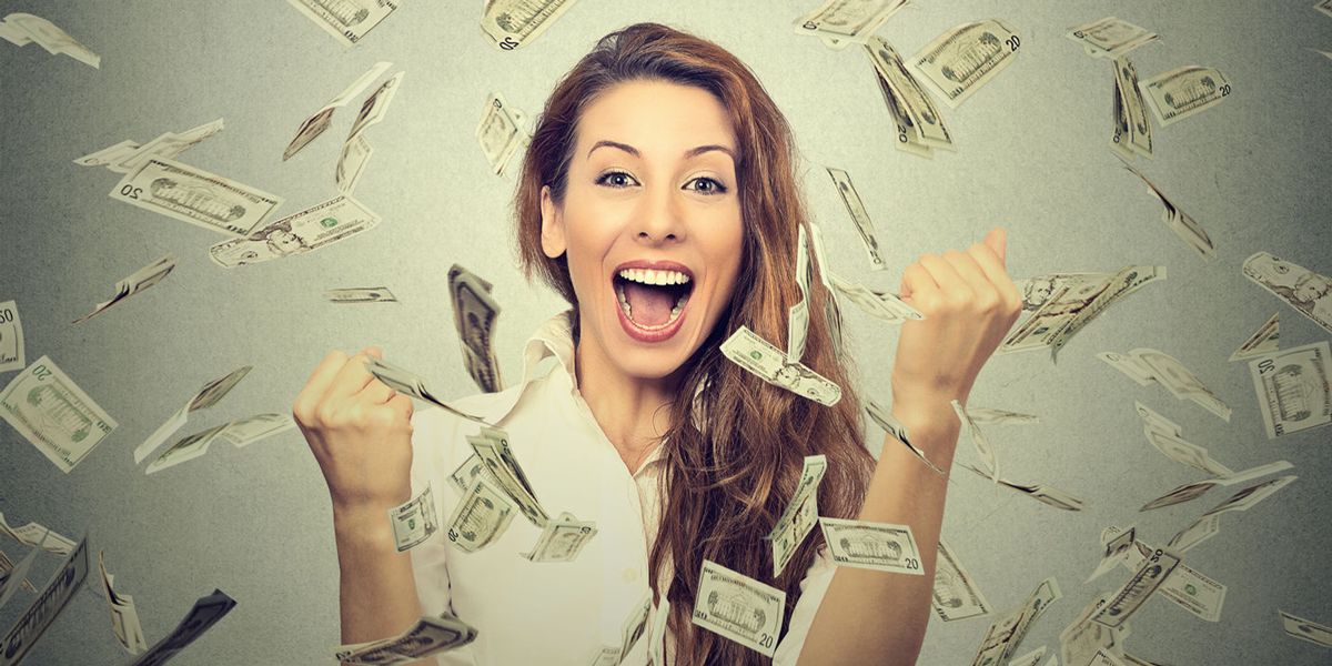 Woman cheering with money flying around her