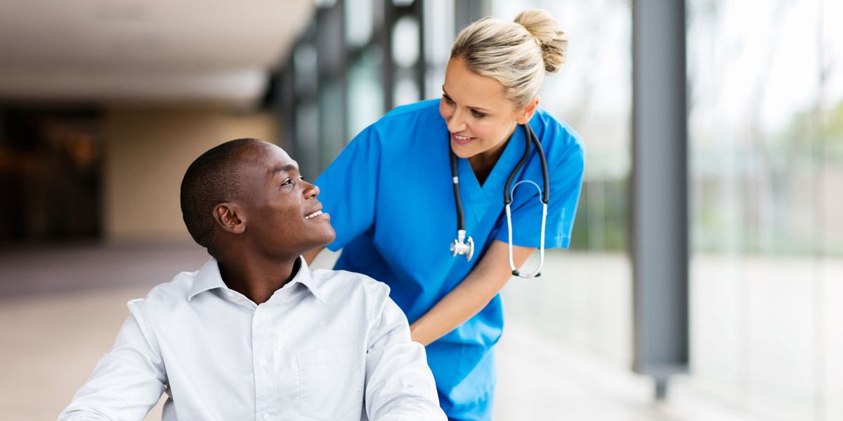 Female nurse helping a male patient