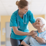 Long term nurse smiling at Senior woman in wheelchair