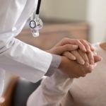 Doctor holding a patient's hand