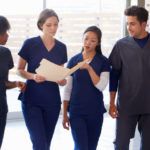Team of four nurses looking at a patient's file