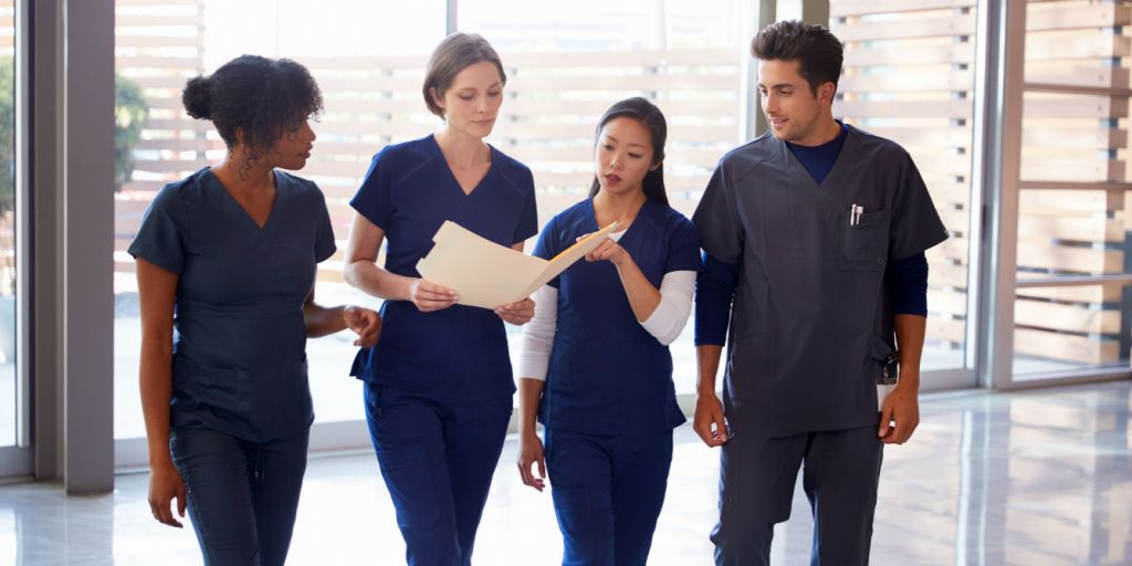 Team of four nurses looking at a patient's file